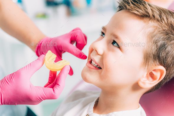 Orthodontist working with little boy